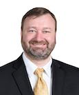 headshot of Paul Battle in a suit and tie